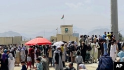 Hundreds of people are seen gathered outside the international airport in Kabul, Afghanistan, Aug. 17, 2021, in hopes of catching a flight out of the country.