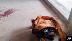 FILE - A school bag lies next to dried blood stains on the floor of a middle school in Let Yet Kone village in Tabayin township in the Sagaing region of Myanmar, Sept. 17, 2022, the day after an air strike hit the school. 