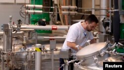 FILE - A Novo Nordisk employee controls a machine at an insulin production line in a plant in Kalundborg, Denmark, Nov. 4, 2013. 