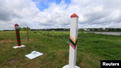 FILE PHOTO: Lithuanian and Russian border signs are seen near Sudargas border crossing point with Russia in Ramoniskiai