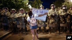 Utah National Guard soldiers stand on a police line as demonstrators gather to protest the death of George Floyd, Thursday, June 4, 2020, near the White House in Washington. Floyd died after being restrained by Minneapolis police officers. (AP Photo…