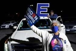Supporters wave signs as Democratic U.S. presidential nominee and former Vice President Joe Biden holds a drive-in campaign rally at Lexington Technology Park in Pittsburgh, Pennsylvania, Nov. 2, 2020.