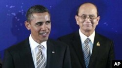 President Barack Obama, left, stands with Myanmar President Thein Sein during a group photo session at the East Asia Summit in Bali, Indonesia, November 19, 2011.