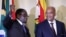 FILE - Zimbabwe's President Robert Mugabe (L) gestures as South Africa's President Jacob Zuma looks on at the end of a press briefing at the Union building in Pretoria, April 8, 2015.