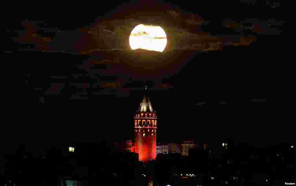 The supermoon is seen over the historical Galata Tower in Istanbul, Turkey.