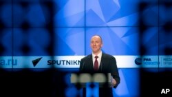 FILE - Carter Page, a former foreign policy adviser to U.S. President-elect Donald Trump, speaks at a news conference at RIA Novosti news agency in Moscow, Russia, Dec. 12, 2016.
