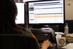 An aide to Congresswoman Veronica Escobar (D-TX) screens calls during in a virtual town hall meeting discussing the novel Corona Virus on March 18, 2020, in El Paso, Texas.