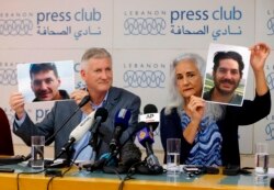 FILE - Marc and Debra Tice, the parents of Austin Tice, who has been missing in Syria since August 2012, hold photos of him during a new conference, at the Press Club, in Beirut, Lebanon, July 20, 2017.