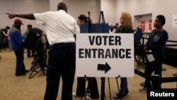 Voters wait in line to cast their ballots during early voting at the Franklin County Board of Elections in Columbus, in Columbus, Ohio.