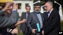 Iran's nuclear chief, Ali Akbar Salehi, right, speaks to journalists during negotiations with the United States over Iran's nuclear program in Lausanne, Switzerland, March 17, 2015. 