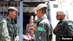 Brazilian soldiers conduct an inspection for the Aedes aegypti mosquito as part of efforts to prevent the spread of the Zika virus, along a street in Sao Paulo, Brazil, Feb. 1, 2016. 