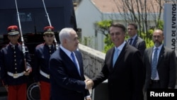 Brazil's President-elect Jair Bolsonaro, right, and Israeli Prime Minister Benjamin Netanyahu shake hands before a lunch in Rio de Janeiro, Brazil, Dec. 28, 2018. 