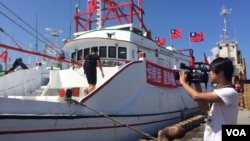 A Taiwanese fishing boat flying national flags prepares to leave for the Taiwan-controlled Taiping Island from Taiwan's southern port city of Pingtung, Wednesday, July 20, 2016. 