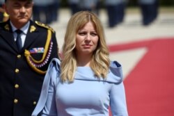FILE - Slovakia's President Zuzana Caputova reviews the guard of honor at the Presidential Palace after her swearing-in ceremony in Bratislava, Slovakia, June 15, 2019.