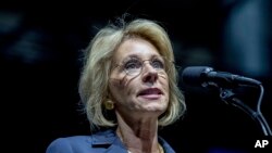 President-elect Donald Trump's pick for Education Secretary Betsy DeVos speaks during a rally at DeltaPlex Arena, Friday, Dec. 9, 2016, in Grand Rapids, Mich.