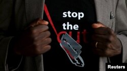 FILE - A T-shirt warns against female genital mutilation. Its wearer attends an event, discouraging harmful practices such as FGM, at a girls high school in Imbirikani, Kenya, April 21, 2016.