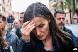 Spain's Queen Letizia reacts as she visits people affected by the floods in Paiporta, near Valencia, Nov. 3, 2024.