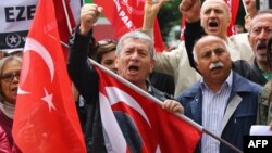 People stage a demonstration in front of the Turkish Parliament in support of a bill to strip immunity of parliamentarians in Ankara, May 4, 2016.
