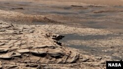 This photo, compiled from 28 images, shows the view from NASA’s Curiosity Mars rover on April 9, 2020. It shows the landscape of the Stimson sandstone formation in Gale Crater. (Photo Credit: NASA/JPL-Caltech/MSSS)