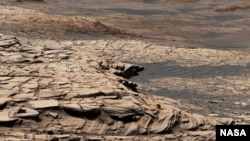 This photo, compiled from 28 images, shows the view from NASA’s Curiosity Mars rover on April 9, 2020. It shows the landscape of the Stimson sandstone formation in Gale Crater. (Photo Credit: NASA/JPL-Caltech/MSSS)