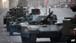FILE - Russian military vehicles are seen making their way to Red Square in preparation for a Victory Day Parade in Moscow.