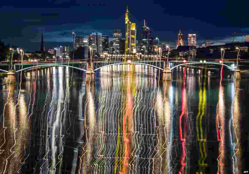 Night lights of the banking district in Frankfurt am Main, western Germany, reflects in the water of the river Main.