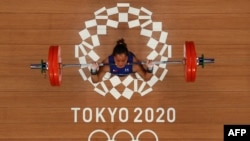 Philippines' Hidilyn Diaz competes in the women's 55kg weightlifting competition during the Tokyo 2020 Olympic Games at the Tokyo International Forum in Tokyo on July 26, 2021. 