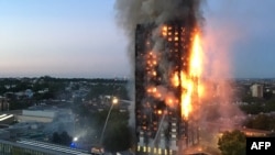 This handout image received by local resident Natalie Oxford early on June 14, 2017 shows flames and smoke coming from a 27-storey block of flats after a fire broke out in west London.