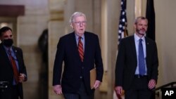 Senate Minority Leader Mitch McConnell, R-Ky., joined by Robert Duncan, the secretary for the minority, walks to the chamber as the Senate works to advance the $1 trillion bipartisan infrastructure bill, at the Capitol in Washington, Aug. 2, 2021