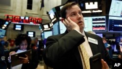Brian Connolly, with NYSE Trading Floor Operations, works on the floor of the New York Stock Exchange during the trading halt, March 12, 2020.