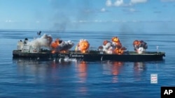 This image from video released by the Ansar Allah Media Office, the media arm of Yemen's Houthi rebels, on Aug. 29, 2024, shows explosions on the Greek-flagged oil tanker Sounion in the Red Sea after Yemen's Houthi rebels boarded and set explosives.