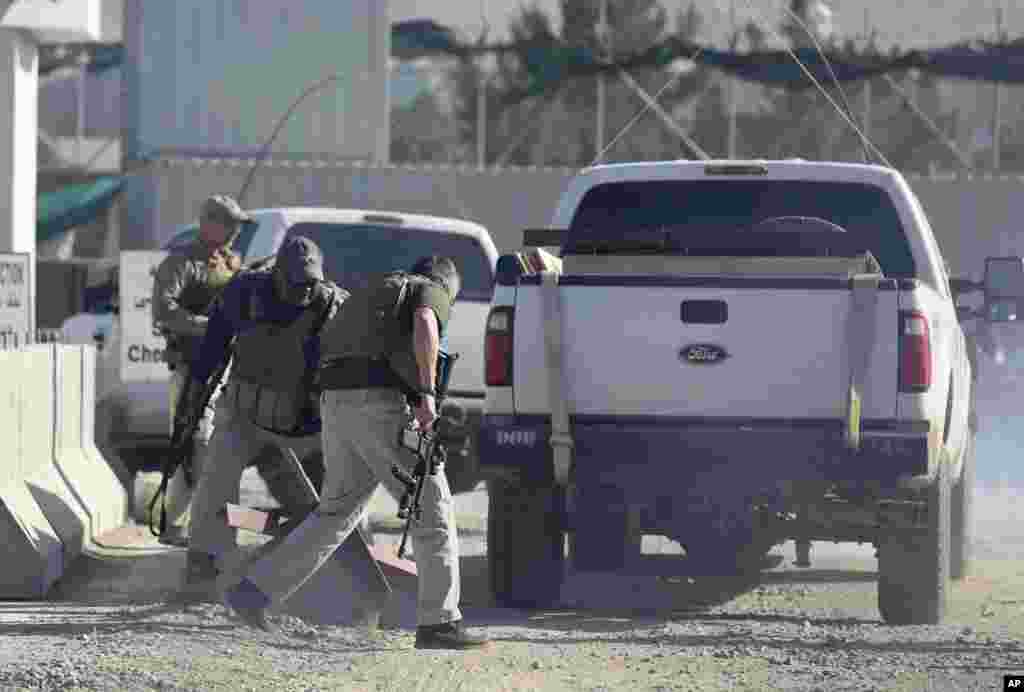 Security forces inspect the site of a suicide attack in the deputy counter-narcotic compound in Kabul, Afghanistan, July 22, 2014.&nbsp;