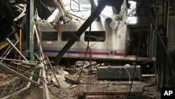 FILE -- This photo provided by the National Transportation Safety Board on Oct. 1, 2016, shows damage done to the Hoboken Terminal in Hoboken, N.J., after a commuter train crash. 