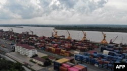 This aerial photo taken on July 9, 2024 shows containers stacked up at the Phnom Penh Autonomous Port New Container Terminal on the Mekong River in Kandal province.