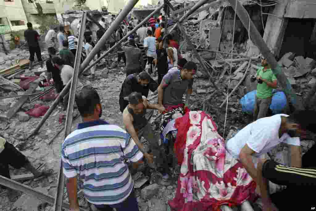Palestinians evacuate a survivor of an Israeli air strike that hit the Al Ghoul family building in Rafah, southern Gaza Strip.