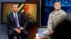 President Barack Obama, accompanied by Tech Sgt. Nathan Parry, takes a question from a service member in Afghanistan, on screen at center, during a town hall with service members at Fort Meade, Md., Sept. 11, 2015.