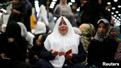 Nahed Ahmed Zeead, 51, dari Irak, ikut melakukan sholat jenazah untuk Muhammad Ali di Louisville, Kentucky, 9 Juni 2016. 