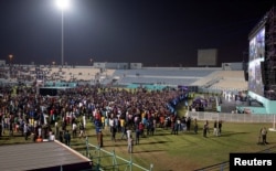 Migrant workers watch Qatar v Ecuador in the special fan zone in Doha, Qatar on November 20, 2022. (REUTERS/Marko Djurica)