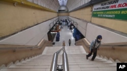 A woman walks on the stairs of a popular Blok M shopping mall normally crowded with shoppers in Jakarta, Indonesia, March 24, 2020.