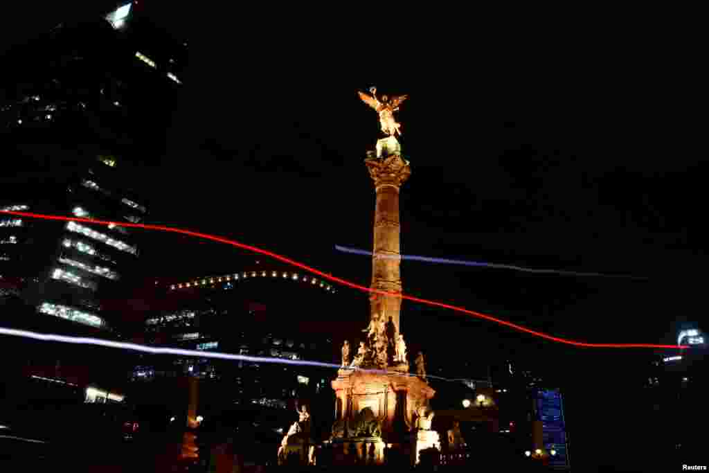 The Angel de la Independencia monument is pictured before lights were turned off for Earth Hour In Mexico City, March 30, 2019.