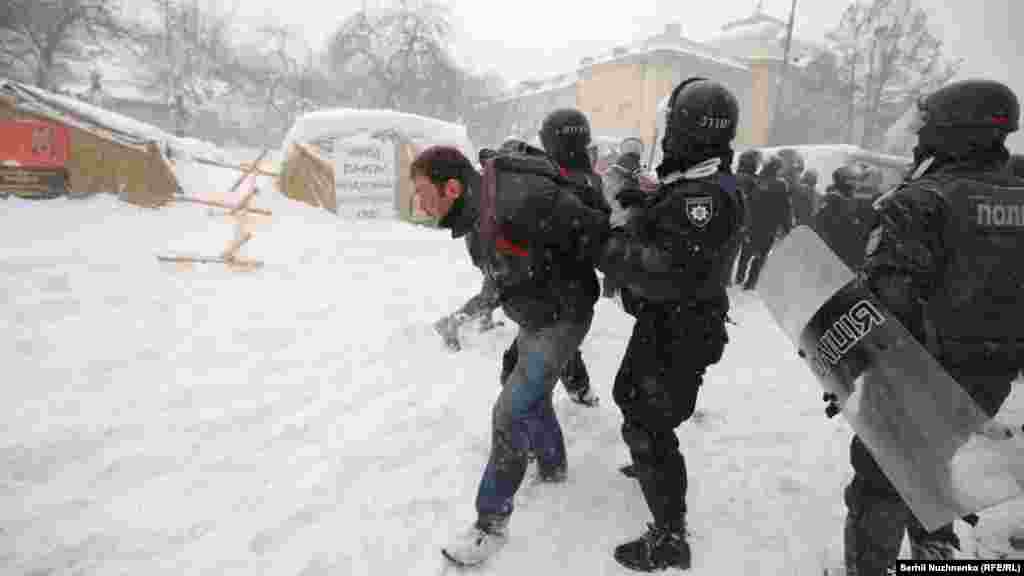 Riot police remove a tent camp set up last October by supporters of Mikheil Saakashvili, who are demanding President Petro Poroshenko resign, detaining over 100 people, in Kyiv, Ukraine, March 3, 2018.