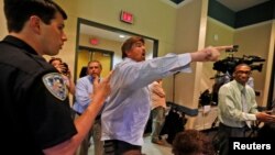 A man yells before being escorted out of a town hall meeting with Republican U.S. Senator Bill Cassidy by law enforcement, in Metairie, Louisiana, Feb. 22, 2017.