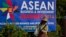 A sweeper cleans a road in the foreground of a billboard promoting Association of Southeast Asian Nations (ASEAN) summit in Naypyitaw, Myanmar, Tuesday, Nov 11, 2014. Myanmar hosts the ASEAN summit and related meetings on Nov. 12 and 13. (AP Photo)