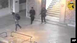 FILE - In this frame made from CCTV and released by the Tunisian government, two gunmen and third unidentified man can be seen inside the Bardo museum in Tunis, March 18, 2015. 