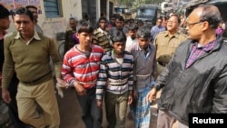 Indian police personnel escort men, tied with rope, who are accused of a gang-rape, to a court at Birbhum district in the eastern Indian state of West Bengal, Jan. 23, 2014.