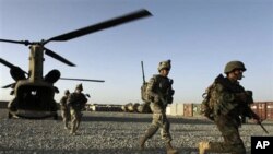 FILE - U.S. infantrymen from the 101st Airborne Division and Afghan army commandos exit a U.S. Army helicopter in Afghanistan's southern Kandahar province, Sept. 11, 2010.