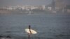 A surfer surveys the waves off Dakar, Senegal. (Annika Hammerschlag/VOA)