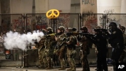Federal agents use crowd control munitions to disperse Black Lives Matter demonstrators during a protest at the Mark O. Hatfield United States Courthouse, July 24, 2020, in Portland, Oregon. 