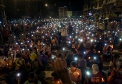 Anti-coup protesters turn on the LED light of their mobile phones during a candlelight night rally in Yangon, Myanmar.