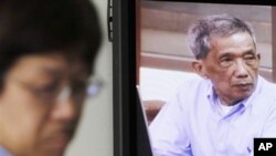 FILE - Kaing Guek Eav, also known as Duch, who ran the notorious Toul Sleng, a top-secret detention center for the worst "enemies" of the state, appears on a television screen of the press center of the U.N.-backed war crimes tribunal in Phnom Penh, 2010.